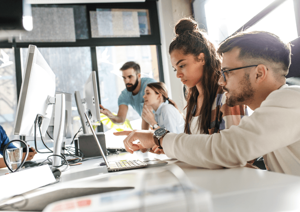 People in an officelooking at computer screens