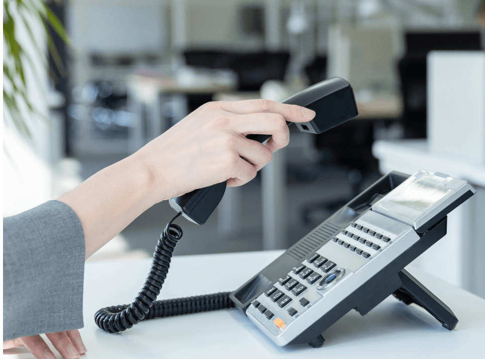 woman holding telephone handset