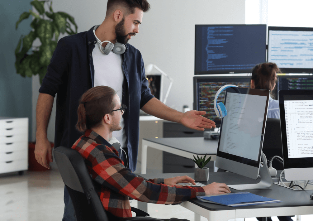 two men looking at a computer screen