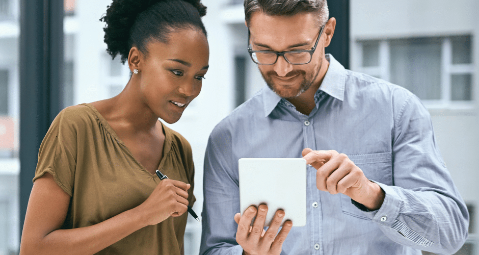 two people looking at a tablet