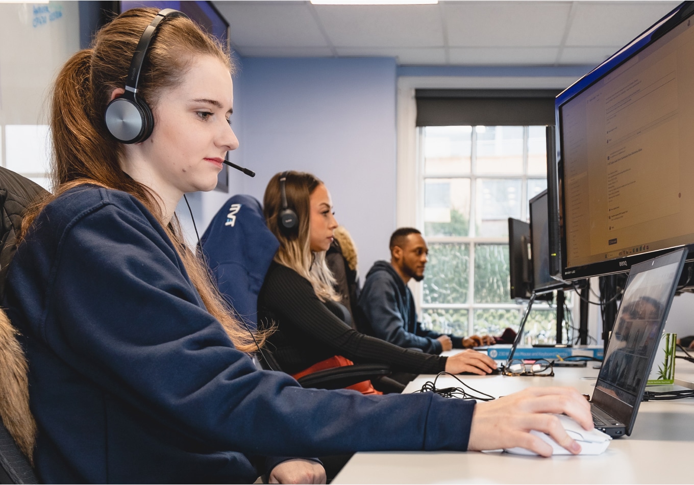 ITVET team sitting working at their desks.